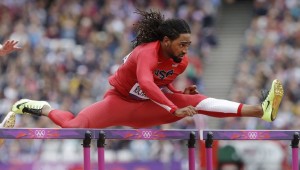 United States' Jason Richardson clears a hurdle in a men's 110-meter hurdles heat during the athletics in the Olympic Stadium at the 2012 Summer Olympics, London, Tuesday, Aug. 7, 2012. (AP Photo/Lee Jin-man)